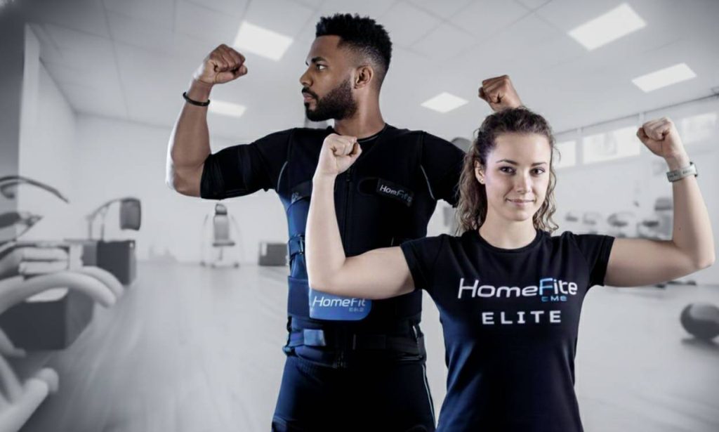 EMS training Abu Dhabi at home with a certified HomeFit Elite personal trainer guiding a full-body session.
