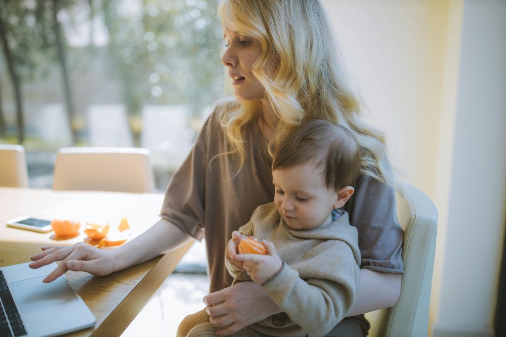A HomeFit Elite certified EMS trainer guiding a busy mom through a private at-home EMS session in Abu Dhabi.